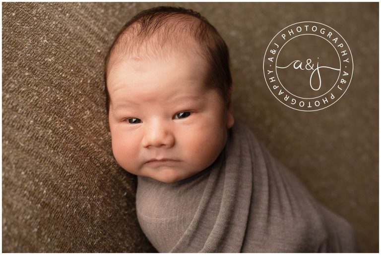 swaddled-baby-brown-backdrop