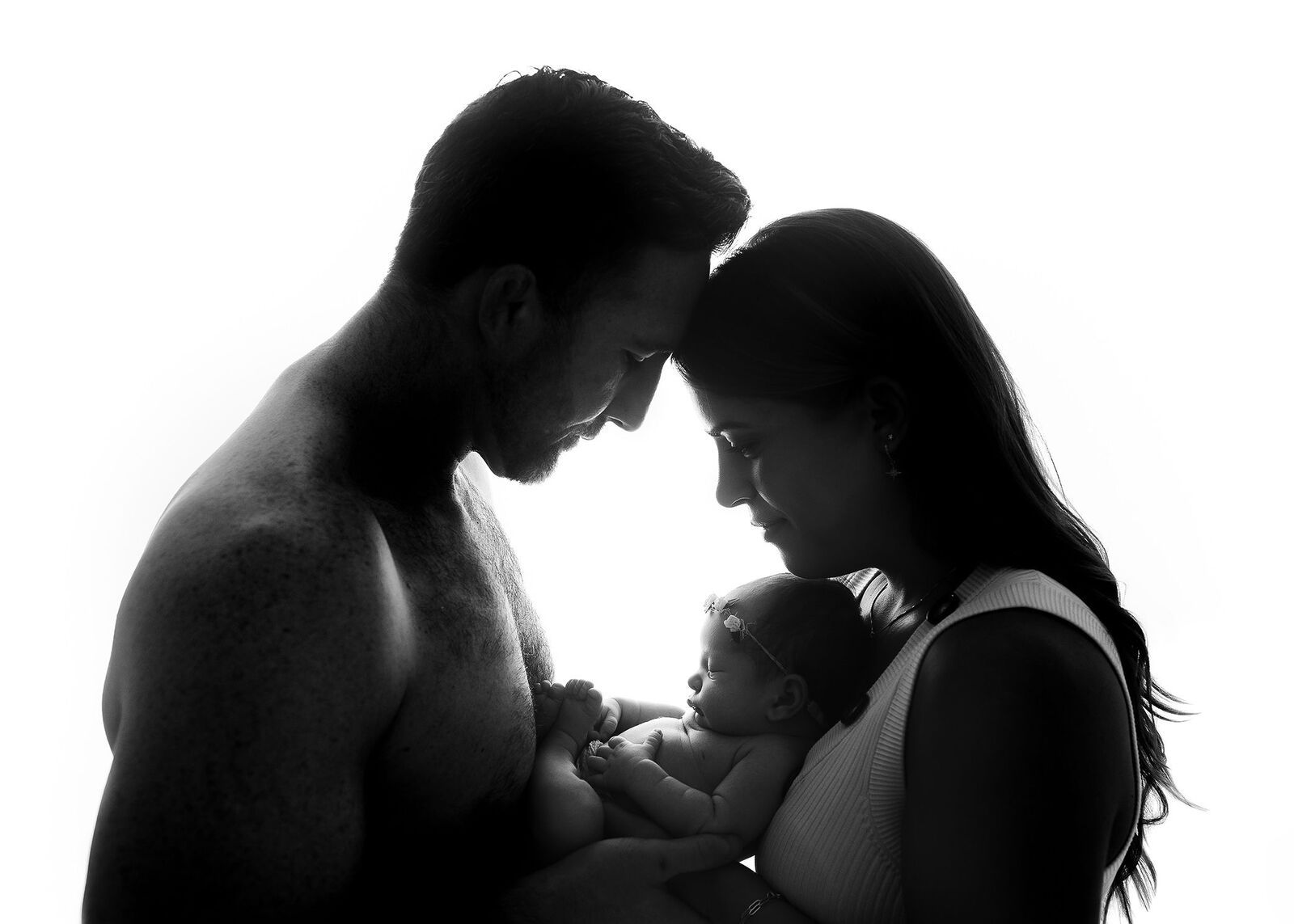 backlit-new-family-cradles-baby